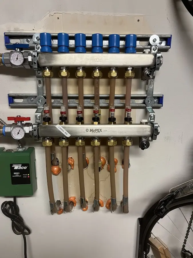 Plumber performing Water Heater Repair at a residential property in Le Roy